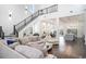 Expansive living area featuring a central staircase, open layout, and easy access to the kitchen at 1279 Fiddlehead Way, Myrtle Beach, SC 29579