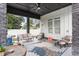 Covered patio with outdoor seating, a ceiling fan, stone pillars, and an inviting backyard design at 1279 Fiddlehead Way, Myrtle Beach, SC 29579