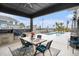 Outdoor patio area featuring a dining table, grill, and views of the private pool and landscaping at 1279 Fiddlehead Way, Myrtle Beach, SC 29579