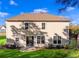 Back view of house with well-kept lawn, sliding glass door and mature trees, and natural light at 1303 Bermuda Grass Dr., Myrtle Beach, SC 29579