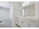 Bathroom with a white vanity, large mirror, and a doorway leading to another room at 1303 Bermuda Grass Dr., Myrtle Beach, SC 29579