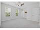 Bedroom with neutral walls, carpet, ceiling fan, and two windows providing natural light at 1303 Bermuda Grass Dr., Myrtle Beach, SC 29579