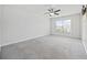Bright bedroom with carpet, neutral paint, ceiling fan, and a large window at 1303 Bermuda Grass Dr., Myrtle Beach, SC 29579