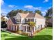 Beautiful two-story home featuring a well-manicured lawn, brick accents, and lush landscaping at 1303 Bermuda Grass Dr., Myrtle Beach, SC 29579