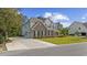 Beautiful two-story home featuring a brick facade, attached garage, a long driveway, and a well-manicured lawn at 1303 Bermuda Grass Dr., Myrtle Beach, SC 29579