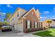 Spacious home showcasing a two-car garage, brick accents, and a well-maintained lawn at 1303 Bermuda Grass Dr., Myrtle Beach, SC 29579