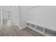 Hallway with wood-look floors and a built-in shelving unit for storage and organization at 1303 Bermuda Grass Dr., Myrtle Beach, SC 29579