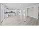 Open floor plan showing white kitchen with island, stainless steel appliances and light filled living area at 1303 Bermuda Grass Dr., Myrtle Beach, SC 29579