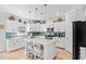 Modern kitchen with white cabinets, quartz countertops, a kitchen island, and stainless steel appliances at 1303 Bermuda Grass Dr., Myrtle Beach, SC 29579