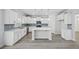 Modern kitchen boasts an island, subway tile backsplash, stainless appliances and white cabinetry at 1303 Bermuda Grass Dr., Myrtle Beach, SC 29579