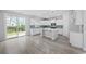 Modern kitchen features white cabinetry, stainless appliances, subway tile backsplash, and a center island at 1303 Bermuda Grass Dr., Myrtle Beach, SC 29579