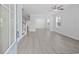Bright living room with modern flooring, fresh paint, large windows, ceiling fan, and views to other rooms at 1303 Bermuda Grass Dr., Myrtle Beach, SC 29579