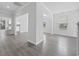 Open-concept living area with luxury vinyl plank flooring, white walls, and views into the kitchen at 1303 Bermuda Grass Dr., Myrtle Beach, SC 29579