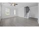 Bright living room featuring luxury vinyl plank flooring, a ceiling fan, staircase and plenty of natural light at 1303 Bermuda Grass Dr., Myrtle Beach, SC 29579