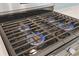 Close-up of a stainless steel stovetop range with blue flames illuminating the burners at 1303 Bermuda Grass Dr., Myrtle Beach, SC 29579