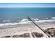 Picturesque beach featuring white sand, clear blue waters, and a long pier perfect for a relaxing day at 1324 Piper Glen Dr, Sunset Beach, NC 28468