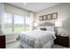 Cozy bedroom with large windows that let in natural light, complemented by neutral decor and stylish furnishings at 1324 Piper Glen Dr, Sunset Beach, NC 28468