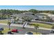 Spacious clubhouse featuring manicured landscaping, palm trees, and ample parking spaces for visitors at 1324 Piper Glen Dr, Sunset Beach, NC 28468