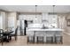 Bright, open kitchen featuring a large center island with seating, white cabinets, and stainless steel appliances at 1324 Piper Glen Dr, Sunset Beach, NC 28468