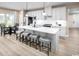 Bright, open kitchen featuring a large center island with seating, white cabinets, and stainless steel appliances at 1324 Piper Glen Dr, Sunset Beach, NC 28468
