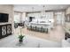 Stylish living room open to the kitchen, with an island, plush seating, and neutral decor at 1324 Piper Glen Dr, Sunset Beach, NC 28468