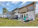 A cozy backyard with a concrete patio, grill, small balconies, and a blue rocking chair at 1360 Turkey Ridge Rd. # A, Surfside Beach, SC 29575