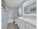 Bathroom with blue walls, shower with tub and curtain, and ample white vanity storage at 1360 Turkey Ridge Rd. # A, Surfside Beach, SC 29575