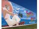 A vibrant mural depicting Surfside Beach, South Carolina, with an ocean backdrop at 1360 Turkey Ridge Rd. # A, Surfside Beach, SC 29575