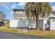 Exterior view of the home with a vibrant palm tree and a white fence with a green door at 1360 Turkey Ridge Rd. # A, Surfside Beach, SC 29575