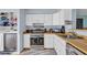 Well-lit kitchen with white cabinets, butcher block countertops, and stainless steel appliances at 1360 Turkey Ridge Rd. # A, Surfside Beach, SC 29575