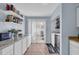 Bright laundry room with stylish countertop, shelving and sliding glass door to outdoor patio at 1360 Turkey Ridge Rd. # A, Surfside Beach, SC 29575