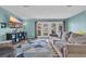 Comfortable living room with large television and access to the outdoors through glass doors at 1360 Turkey Ridge Rd. # A, Surfside Beach, SC 29575