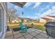 Charming backyard patio with an aqua rocking chair and peaceful outdoor space at 1360 Turkey Ridge Rd. # A, Surfside Beach, SC 29575