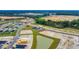 Wide aerial view of a developing residential area with new homes, ponds, construction sites, and green spaces at 1372 Palm Springs Paloma Dr, Longs, SC 29568