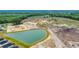 A sprawling construction site with heavy machinery, a newly formed pond, and a glimpse of the surrounding green landscape at 1372 Palm Springs Paloma Dr, Longs, SC 29568