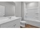 Bright bathroom featuring a tub with shower, a white vanity and wood-look flooring at 1372 Palm Springs Paloma Dr, Longs, SC 29568