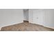A bright bedroom with wood-look flooring and a closet with double doors at 1372 Palm Springs Paloma Dr, Longs, SC 29568