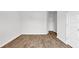 A bedroom with wood-look floors and white trim for a clean, modern look at 1372 Palm Springs Paloma Dr, Longs, SC 29568