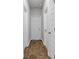 Hallway featuring multiple doors and durable wood-style floors with a neutral wall color at 1372 Palm Springs Paloma Dr, Longs, SC 29568