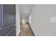 Inviting hallway with wood-look flooring leading to a bright living space, enhanced by natural light at 1372 Palm Springs Paloma Dr, Longs, SC 29568