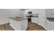 Modern kitchen showcasing granite countertops, stainless steel appliances, and sleek white cabinetry at 1372 Palm Springs Paloma Dr, Longs, SC 29568