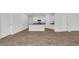Contemporary kitchen with white cabinets, granite countertops, and stainless steel appliances, flowing into living area at 1372 Palm Springs Paloma Dr, Longs, SC 29568
