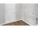 Bright laundry room with convenient washer/dryer hookups and overhead wire shelving at 1372 Palm Springs Paloma Dr, Longs, SC 29568