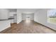 Open-concept living room with stylish flooring, bright white walls, and sliding glass doors to the outdoors at 1372 Palm Springs Paloma Dr, Longs, SC 29568