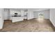 Spacious living area featuring stylish flooring, a modern kitchen, and abundant natural light at 1372 Palm Springs Paloma Dr, Longs, SC 29568