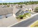 Aerial view of home with driveway, landscaping, roof, and neighborhood at 1435 Saint Thomas Circle # E-1, Myrtle Beach, SC 29577