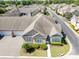 Overhead view of the house with attached garage, manicured front lawn, and beautiful landscaping at 1435 Saint Thomas Circle # E-1, Myrtle Beach, SC 29577