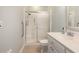 Small bathroom features a shower with sliding glass doors, handrails, white sink and tile flooring at 1435 Saint Thomas Circle # E-1, Myrtle Beach, SC 29577