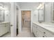 Bathroom featuring a white marble countertop, marble tiled floor, large mirror, and walk-in shower at 1435 Saint Thomas Circle # E-1, Myrtle Beach, SC 29577