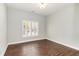 Bright bedroom features hardwood floors and a window with plantation shutters at 1435 Saint Thomas Circle # E-1, Myrtle Beach, SC 29577